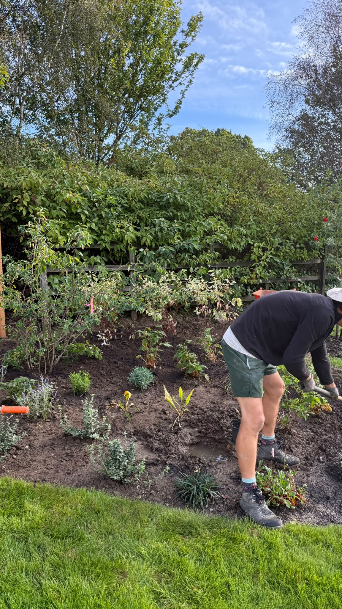 Team member tending newly planted beds on a garden aftercare visit