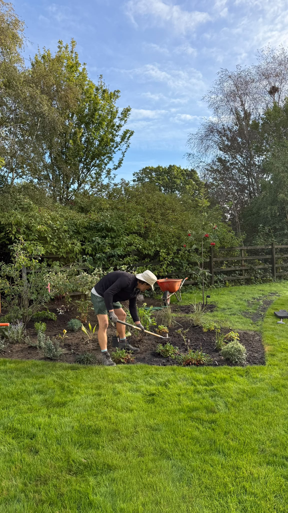 Aftercare team working planting beds across a large managed lawn