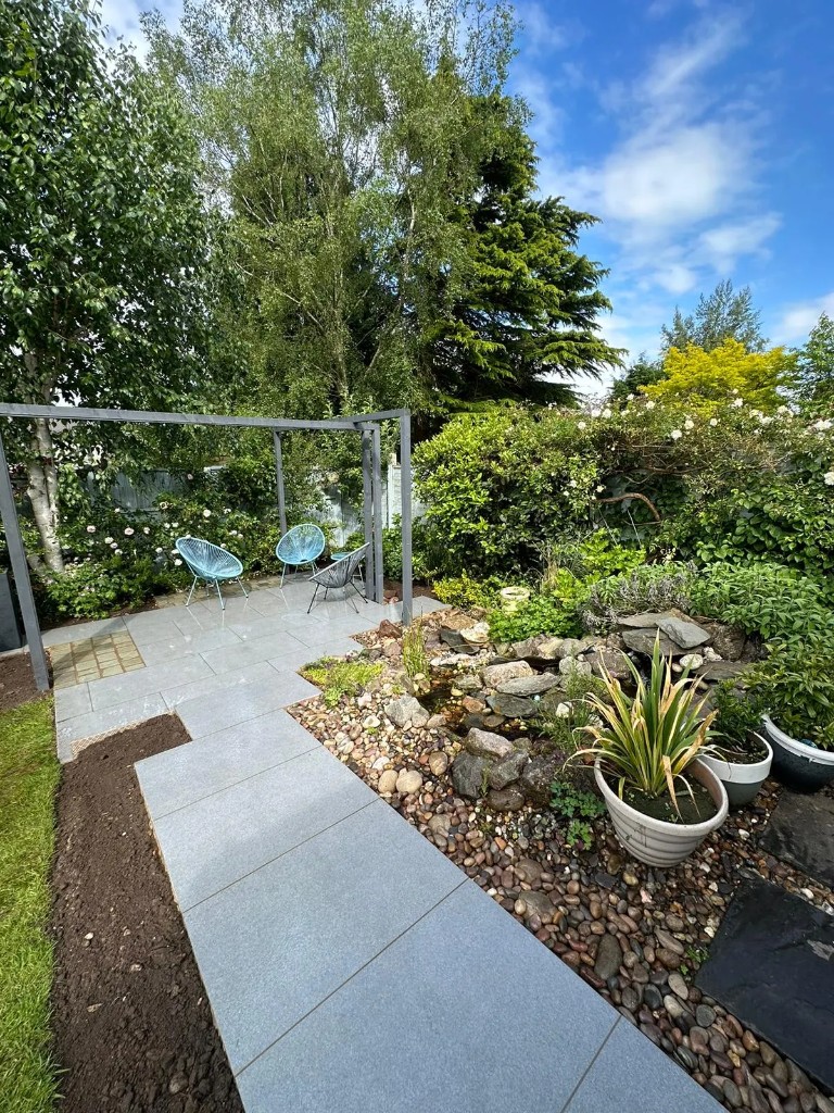 Patio path, pebble bed and pergola chairs in Jill Cottrell's finished garden