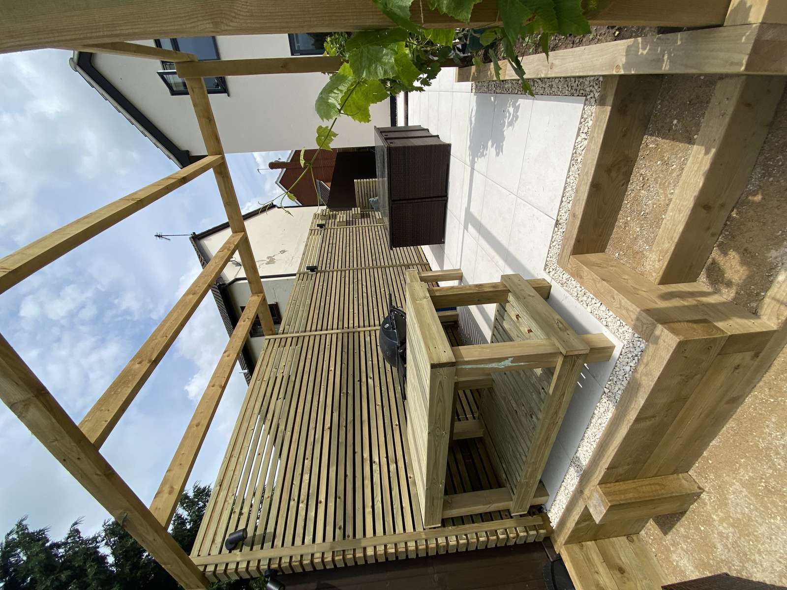 Multi-level family garden in Quorn, Leicestershire with porcelain patio, outdoor kitchen, hot tub area and pergolas