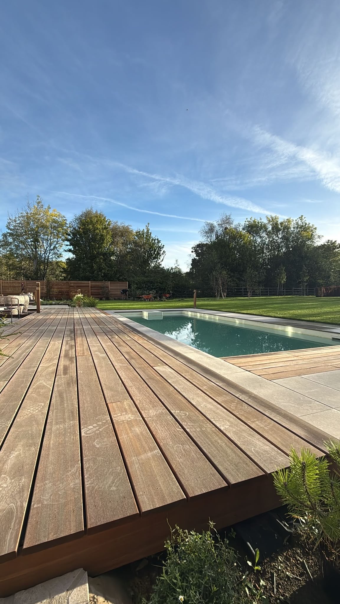 Hardwood decking framing the pool with lawn beyond